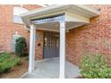 Close-up of building entrance with covered entry and brick facade, showing the unit addresses at 14624 Via Sorrento Dr # 6206, Charlotte, NC 28277