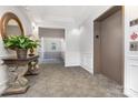 Well-lit hallway with neutral tones, decorative table, and convenient elevator access for residents at 14624 Via Sorrento Dr # 6206, Charlotte, NC 28277
