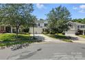 Beautiful home with a two-car garage and a long driveway, framed by mature trees and well-maintained lawn at 15508 Normans Landing Dr, Charlotte, NC 28273