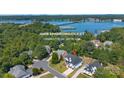 Aerial view of house, located near a lake and surrounded by lush greenery at 15818 Sparrowridge Ct, Charlotte, NC 28278