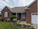 Charming single-story brick home with a well-manicured lawn and tasteful landscaping at 1764 Pipers Ridge Nw Cir, Conover, NC 28613