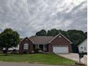 Charming single-story brick home featuring an attached two-car garage and well-maintained landscaping at 1764 Pipers Ridge Nw Cir, Conover, NC 28613