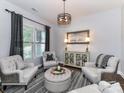Comfortable living room featuring neutral tones, stylish furnishings, and ample natural light from the windows at 2005 Arbor Hills Dr, Indian Trail, NC 28079