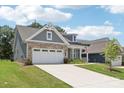 Beautiful home featuring a long driveway, well-maintained lawn, and a mix of siding and brick exterior at 3022 Trace Meadow Ct, York, SC 29745
