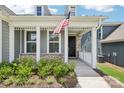 Inviting front porch with classic white columns and detailed trim, accented by lush landscaping at 3022 Trace Meadow Ct, York, SC 29745