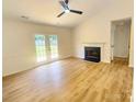 Cozy living room showcasing a fireplace, patio doors, and a ceiling fan, creating a comfortable living space at 3106 Faircroft Way, Monroe, NC 28110