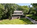Beautiful home with a welcoming front porch, lush lawn, and driveway, nestled among mature trees at 408 Camelot Dr, Salisbury, NC 28144