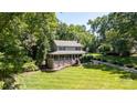 Picturesque home with a large front yard, expansive porch, and mature trees providing privacy at 408 Camelot Dr, Salisbury, NC 28144