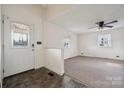 Bright living room featuring neutral walls, carpet, and a ceiling fan for comfortable living at 411 S Central Ave, Landis, NC 28088