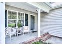 Inviting front porch with seating, creating a cozy and welcoming entrance to the home at 5437 Mallard Ln, Gastonia, NC 28052