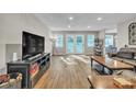 Spacious living room with hardwood floors, recessed lighting, and access to the backyard through glass doors at 5476 Twelve Oak Ln, Conover, NC 28613