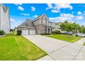 Beautiful exterior view of home showcasing well-maintained lawn, a two-car garage, and well-kept landscaping at 586 Brookhaven Dr, Fort Mill, SC 29708