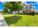 Lush green lawn and mature trees accentuate this charming home's curb appeal in a tranquil neighborhood at 586 Brookhaven Dr, Fort Mill, SC 29708