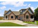 Charming home with stone and siding exterior, well-manicured lawn and spacious driveway at 5985 Natoma Rd, Clover, SC 29710