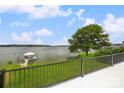 Beautiful waterfront view from the home featuring a private dock and lush landscaping with a bright blue sky at 5985 Natoma Rd, Clover, SC 29710
