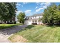 Charming two-story traditional home with a welcoming front porch, two-car garage, and landscaped front yard on a sunny day at 6603 Brenock Ln, Charlotte, NC 28269