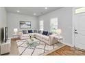 Bright and airy living room with plush seating, modern decor, and ample natural light at 7079 Waterwheel Sw St, Concord, NC 28025