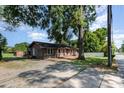 Single story home with wood siding and light pink trim on a gravel lot with mature trees at 816 Radio Rd, Statesville, NC 28677