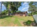 Quaint single story home with light pink trim, set on a green lawn under a mature shade tree at 816 Radio Rd, Statesville, NC 28677