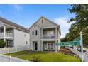 Charming two-story home with double balconies near a street sign for Grier Springs in a beautiful neighborhood at 9704 Grier Springs Ln, Charlotte, NC 28213