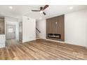 Bright living room with wood floors, fireplace accent wall, and a ceiling fan at 101 Bryan St, Kannapolis, NC 28083