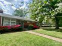 Lovely ranch home with stone accents, colorful azaleas, and a well-maintained lawn at 1017 Andover Rd, Charlotte, NC 28211