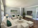 Bright living room featuring neutral furniture, hardwood floors, and ample natural light at 1017 Andover Rd, Charlotte, NC 28211