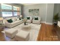 Bright living room featuring neutral furniture, hardwood floors, and ample natural light at 1017 Andover Rd, Charlotte, NC 28211