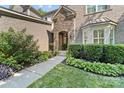 Charming stone-accented entrance with well-manicured landscaping and a welcoming walkway at 10320 Lemington Dr, Mint Hill, NC 28227