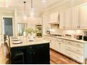Spacious kitchen with granite countertops, stainless steel appliances, and a large island at 104 Bunker Way, Mooresville, NC 28117