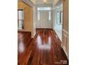 Bright foyer with gleaming hardwood floors and detailed white molding at 10607 Old Bridge Ln, Charlotte, NC 28269