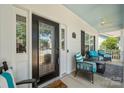 A cozy front porch with stylish seating, featuring a decorative fan and a patterned rug, creating a welcoming entrance at 1103 Phar Lap Dr, Indian Trail, NC 28079