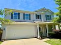 Desirable home with a two-car garage, a welcoming front porch, and green landscaping near the front entrance at 11109 Pond Valley Ct, Charlotte, NC 28269