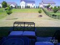 View of backyard with wrought iron patio furniture and a view of fenced yard at 1141 Overlake Dr, Belmont, NC 28012