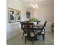 Formal dining room with modern chandelier and wainscoting at 1141 Overlake Dr, Belmont, NC 28012