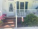 Close-up of the front porch area with brick steps and decorative plants at 2174 Eastview Rd, Rock Hill, SC 29732