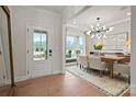 Bright dining room features a modern chandelier, large windows with views, and an adjacent doorway at 2192 Millennium Dr # 91, Lancaster, SC 29720