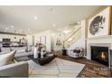 Spacious open-concept living room featuring a fireplace, staircase and eat-in kitchen at 2198 Millennium Dr # 90, Lancaster, SC 29720