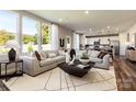 Open-concept living room with large windows, neutral tones, and stylish furnishings at 2198 Millennium Dr # 90, Lancaster, SC 29720