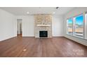Spacious living room featuring a cozy fireplace, hardwood floors, and plenty of natural light from large windows at 2202 Millennium Dr # 89, Lancaster, SC 29720