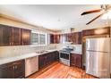 Well-lit kitchen with stainless appliances, dark wood cabinetry, and modern countertops at 2405 Greenland Ave, Charlotte, NC 28208