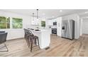 Contemporary kitchen boasts white cabinets, quartz counters, and stainless steel appliances at 2610 Fairgreen Dr, Gastonia, NC 28056