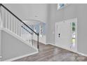 Bright entryway with wood-look floors, staircase, and view into a living area with plenty of natural light at 280 Glenn Allen Rd, Mooresville, NC 28115