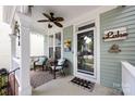 A cozy front porch provides comfortable seating, decorative pillows and a ceiling fan perfect for relaxing outdoors at 298 Bridges Farm Rd, Mooresville, NC 28115