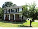 Inviting two-story house featuring a cozy front porch and attractive landscaping at 315 Second St, Stanley, NC 28164