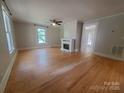 Spacious living room with hardwood floors, a ceiling fan, and a decorative fireplace at 315 Second St, Stanley, NC 28164