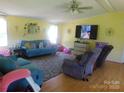 Cozy living room with hardwood floors, a ceiling fan, and comfortable seating at 33343 Old Salisbury Rd, Albemarle, NC 28001