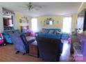A spacious living room features natural light, laminate flooring and a ceiling fan at 33343 Old Salisbury Rd, Albemarle, NC 28001