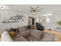 Open concept living room featuring a cozy sectional sofa, wood floors, and modern furnishings at 389 Whispering Hills Dr, Locust, NC 28097