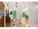 Bright foyer featuring hardwood floors, a decorative rug, and a glimpse into the dining room at 5008 Saddle Horn Trl, Weddington, NC 28104